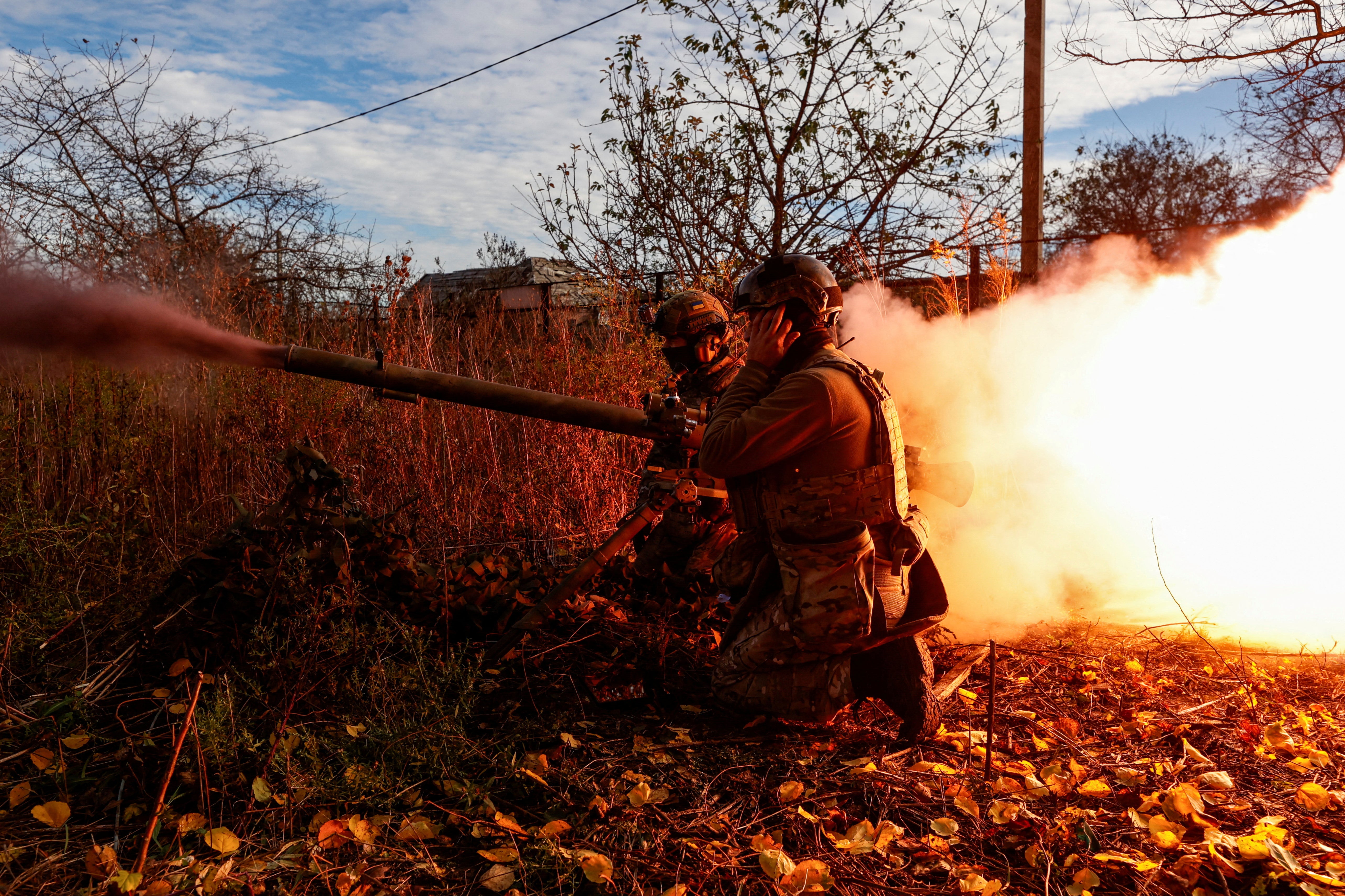 Ukrainian soldiers fire an anti-tank grenade launcher towards Russian troops in Avdiivka