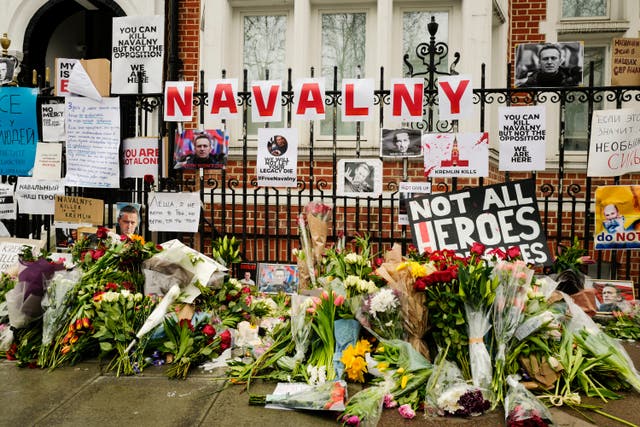 <p>Flowers and tributes are left opposite the Russian embassy, to commemorate the death of Alexei Navalny in London</p>