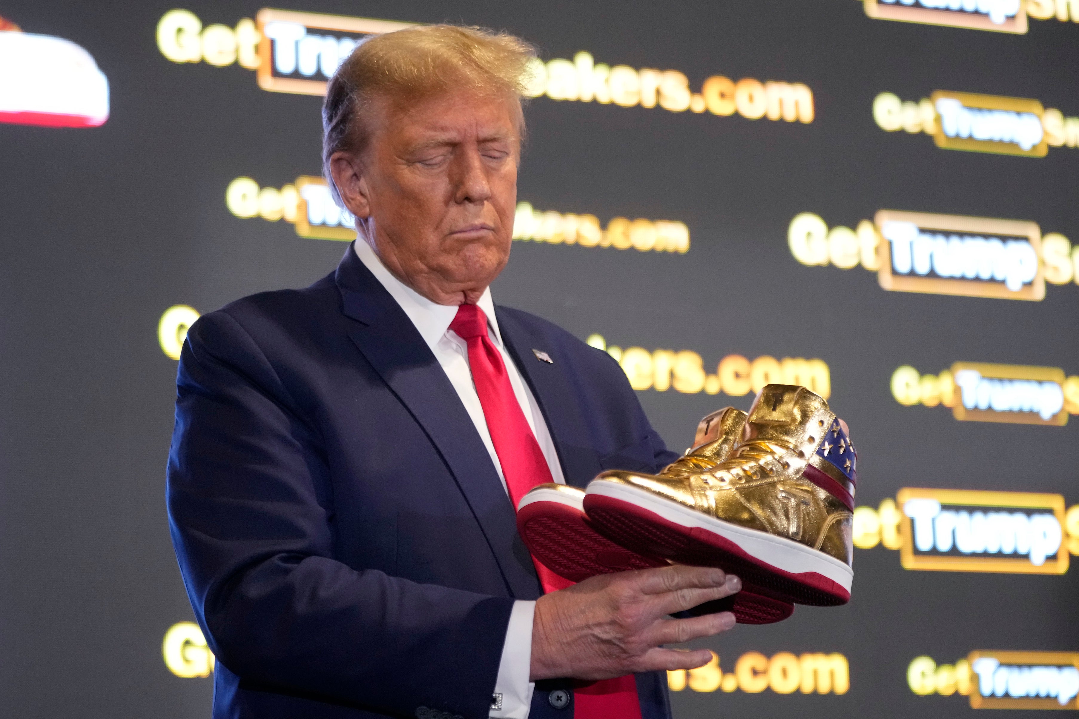 Donald Trump examining the shoes at Sneaker Con
