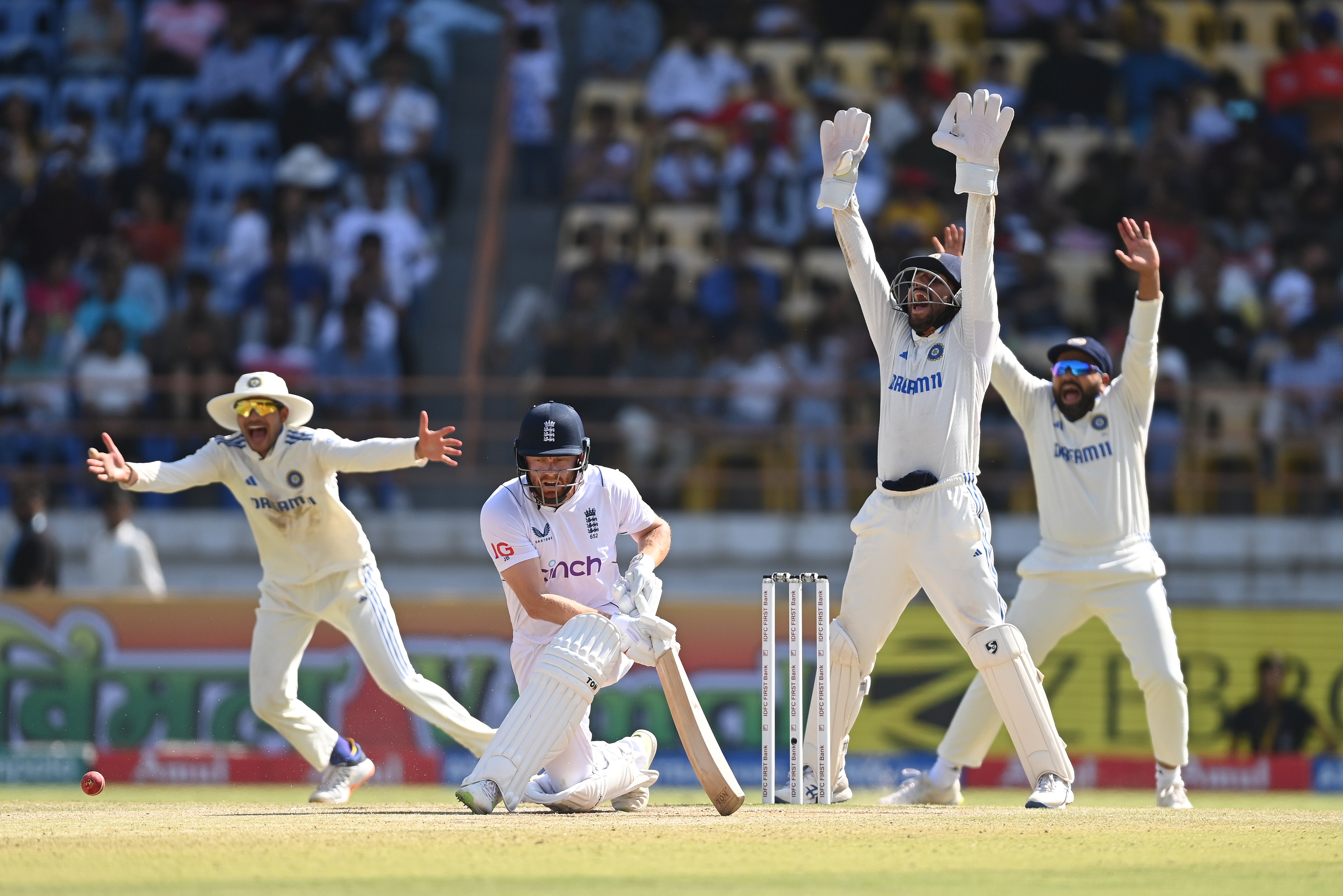 India wicketkeeper Dhruv Jurel and teammates appeal with success for the wicket of Jonny Bairstow, lbw to Ravindra Jadeja