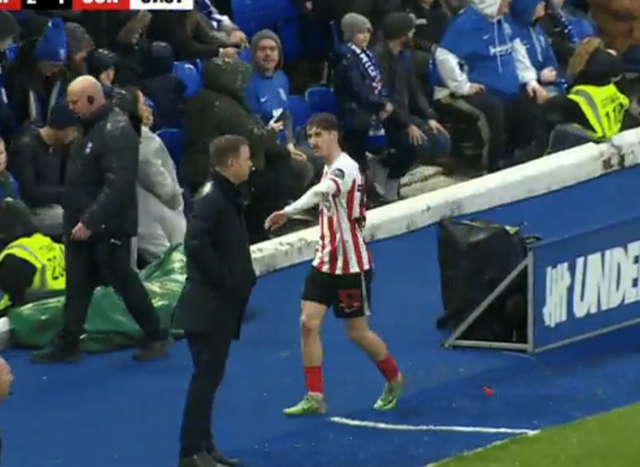 <p>Sunderland defender Trai Hume offers his hand to manager Michael Beale, who does not react</p>