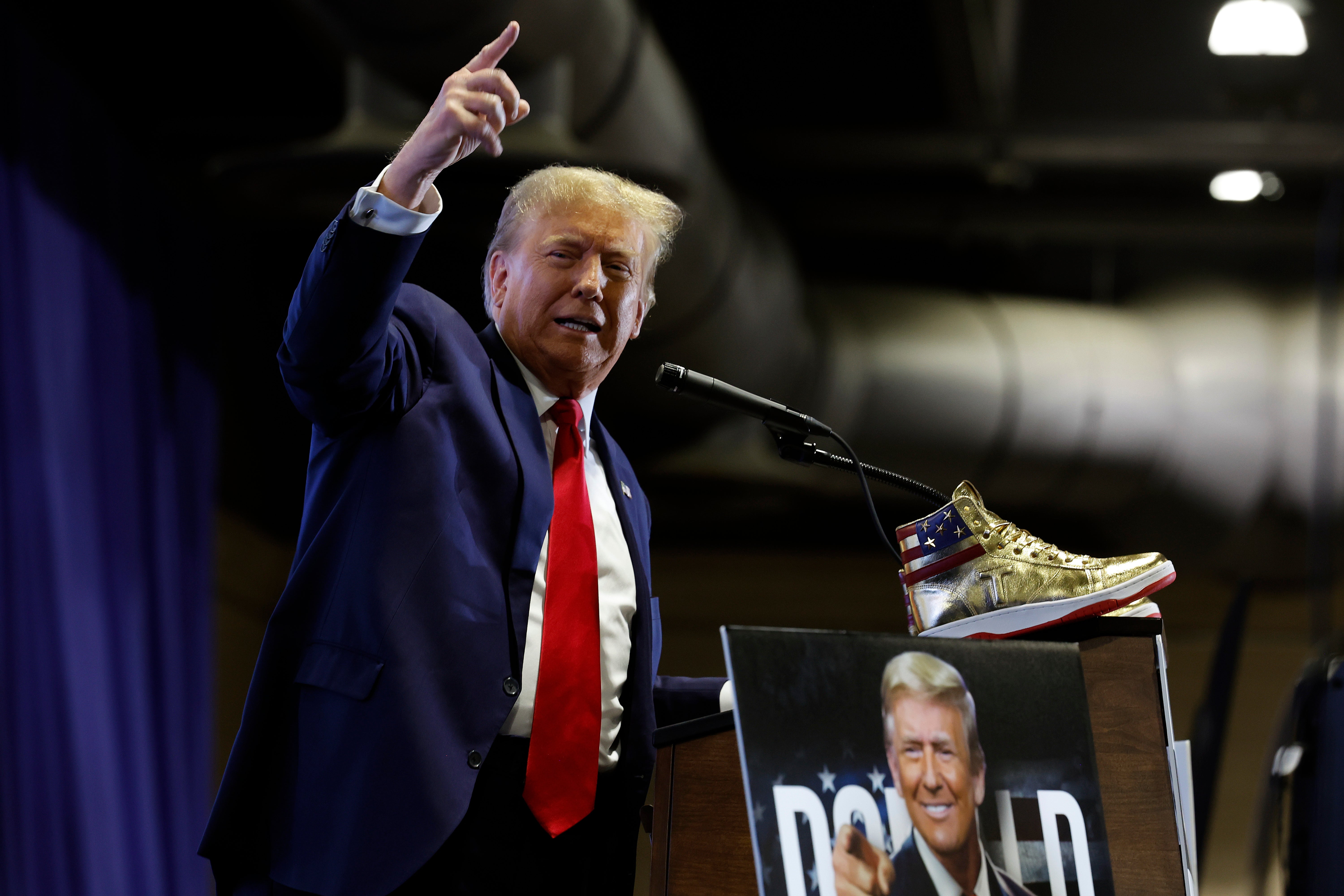 <p>Donald Trump takes the stage to introduce a new line of signature shoes at Sneaker Con at the Philadelphia Convention Center on 17 February 2024</p>