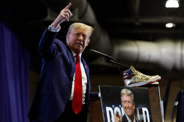 <p>Donald Trump takes the stage to introduce a new line of signature shoes at Sneaker Con at the Philadelphia Convention Center on 17 February 2024</p>