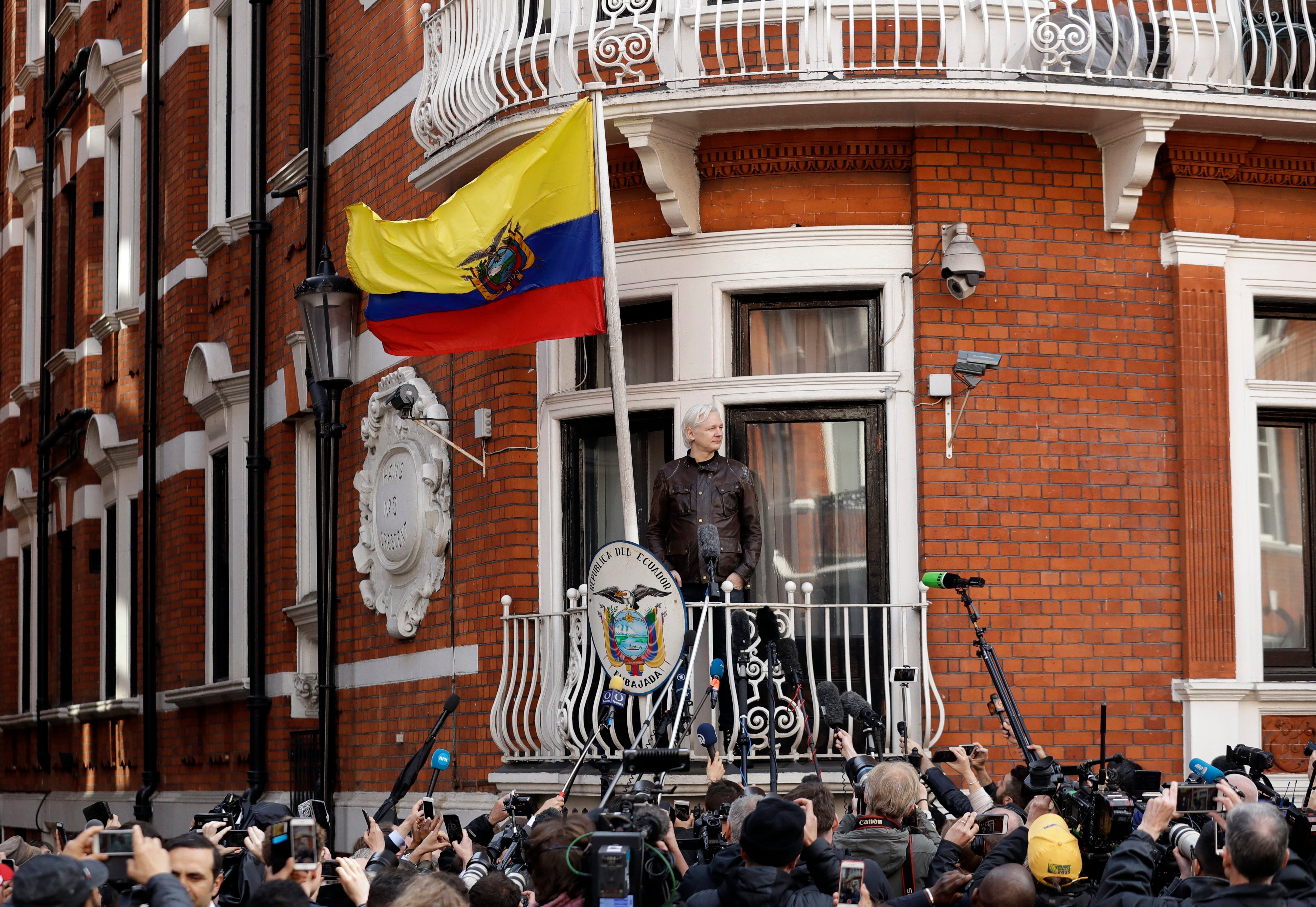 WikiLeaks founder Julian Assange gestures on the balcony of the Ecuadorian embassy prior to speaking, in London,