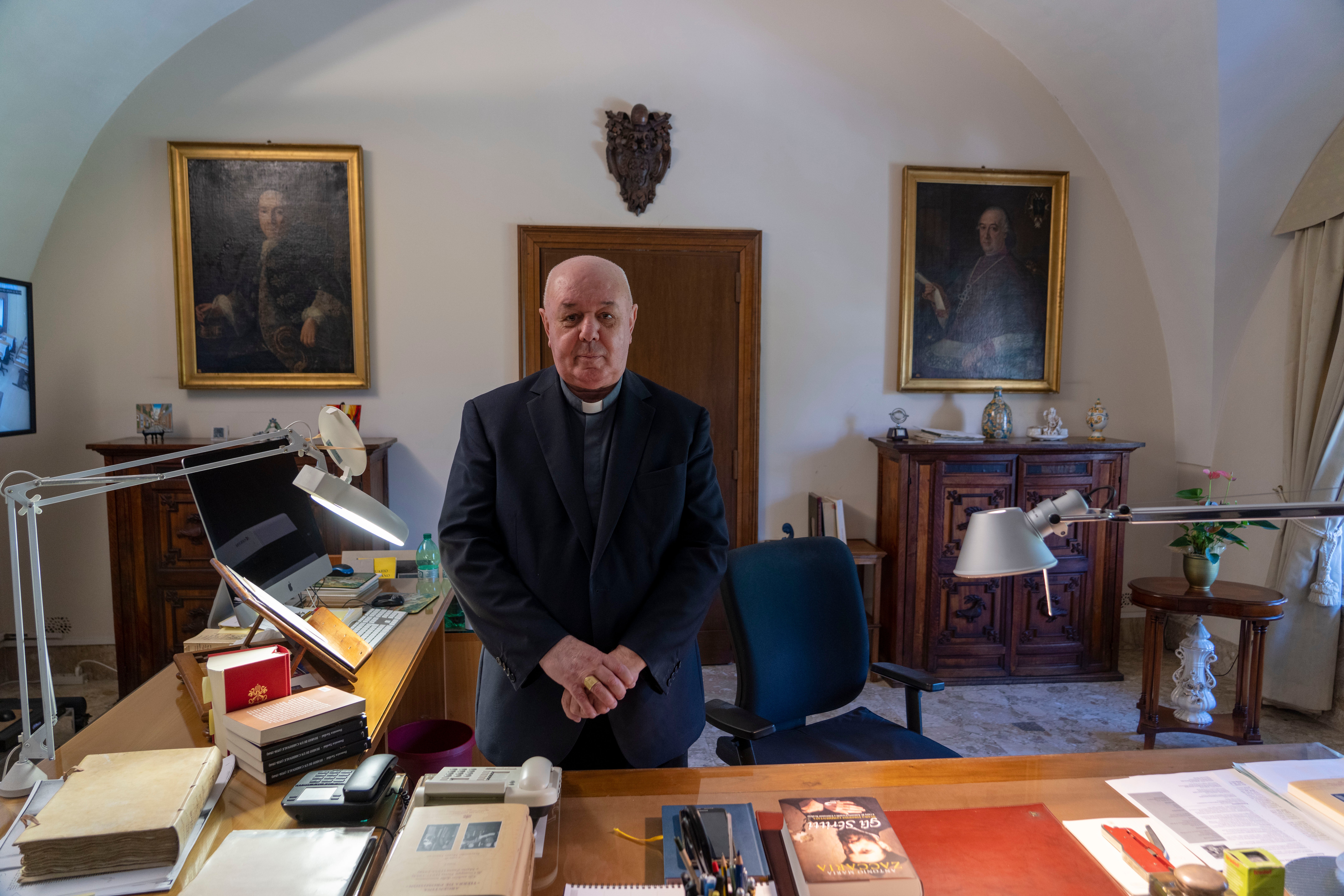 Pagano, who will retire later this year, poses in his office at the Vatican