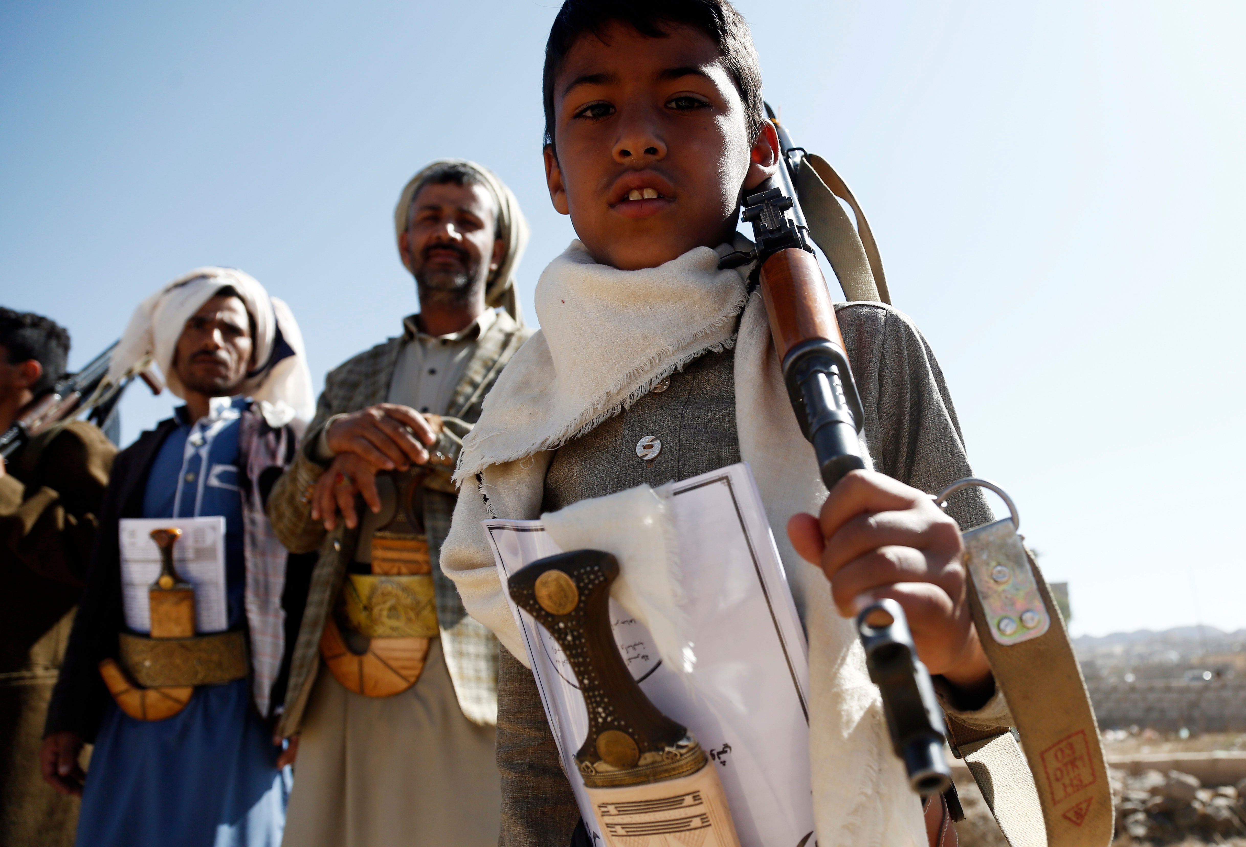 A Yemeni child carries a rifle as he participates with Houthi followers in a rally staged in solidarity with Palestinians