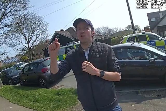 <p>Luke D’Wit speaking to police officers (Essex Police/PA)</p>