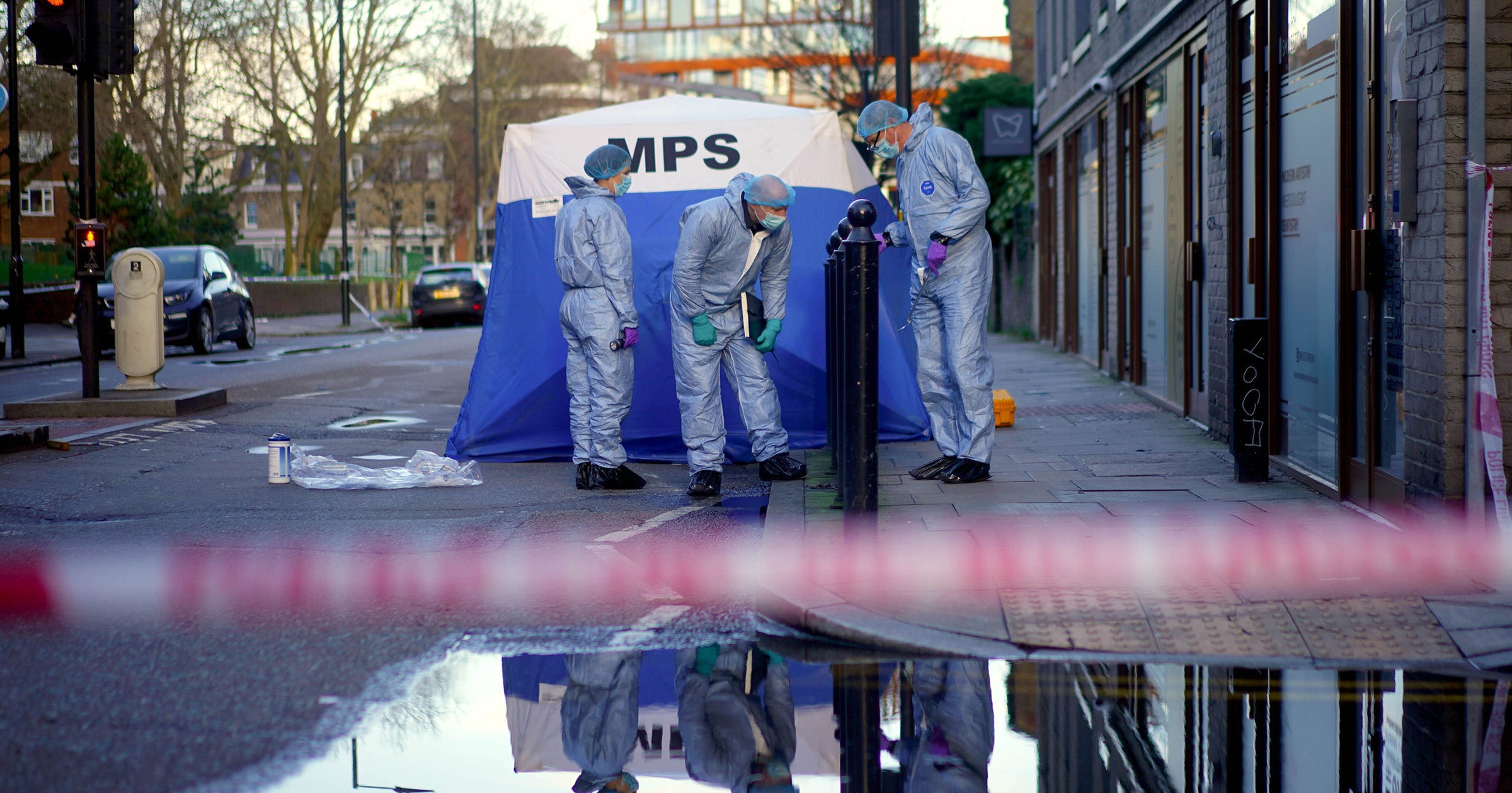 Forensic officers work near to the scene