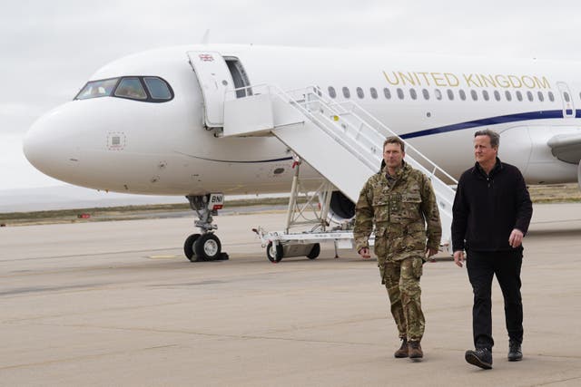 Foreign Secretary Lord David Cameron, right, arrives at Mount Pleasant airbase on the Falkland Islands (Stefan Rousseau/PA)