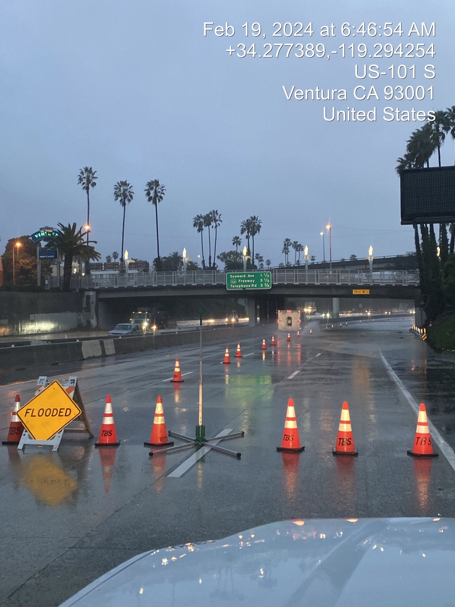 Cones and signs block off a portion os US-101 in Ventura, California as heavy rain pours down