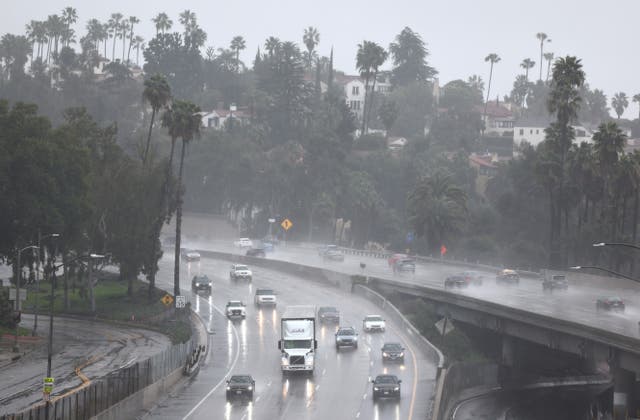 <p>Cars drive through torrential rain on US-101 in Los Angeles on 19 February 2024</p>