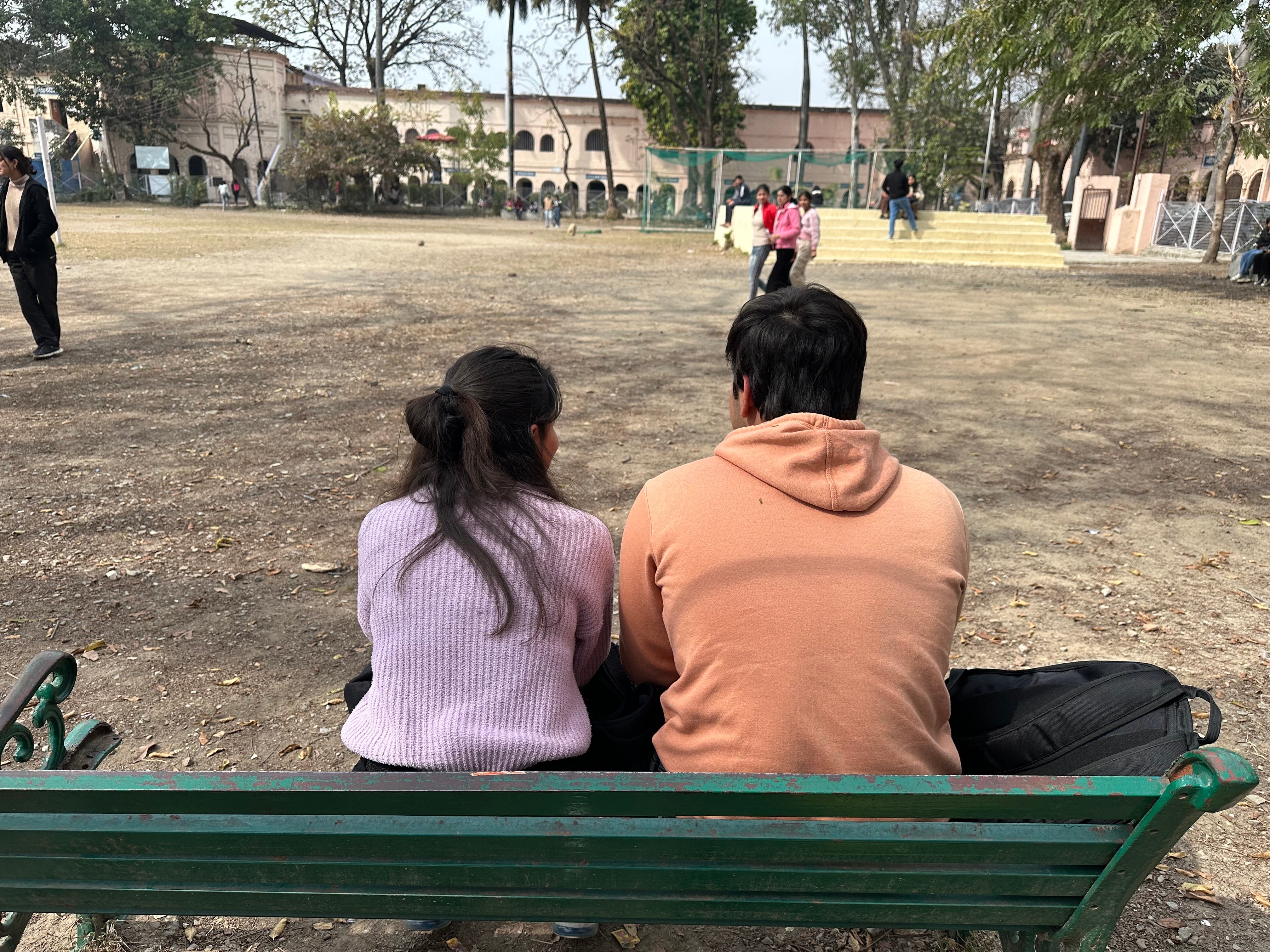 A couple sits outside a college in Dehradun, Uttarakhand, where a new ‘uniform civil code’ has been passed by the BJP government