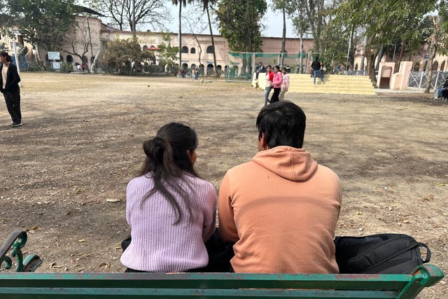 <p>A couple sits outside a college in Dehradun, Uttarakhand, where a new ‘uniform civil code’ has been passed by the BJP government</p>