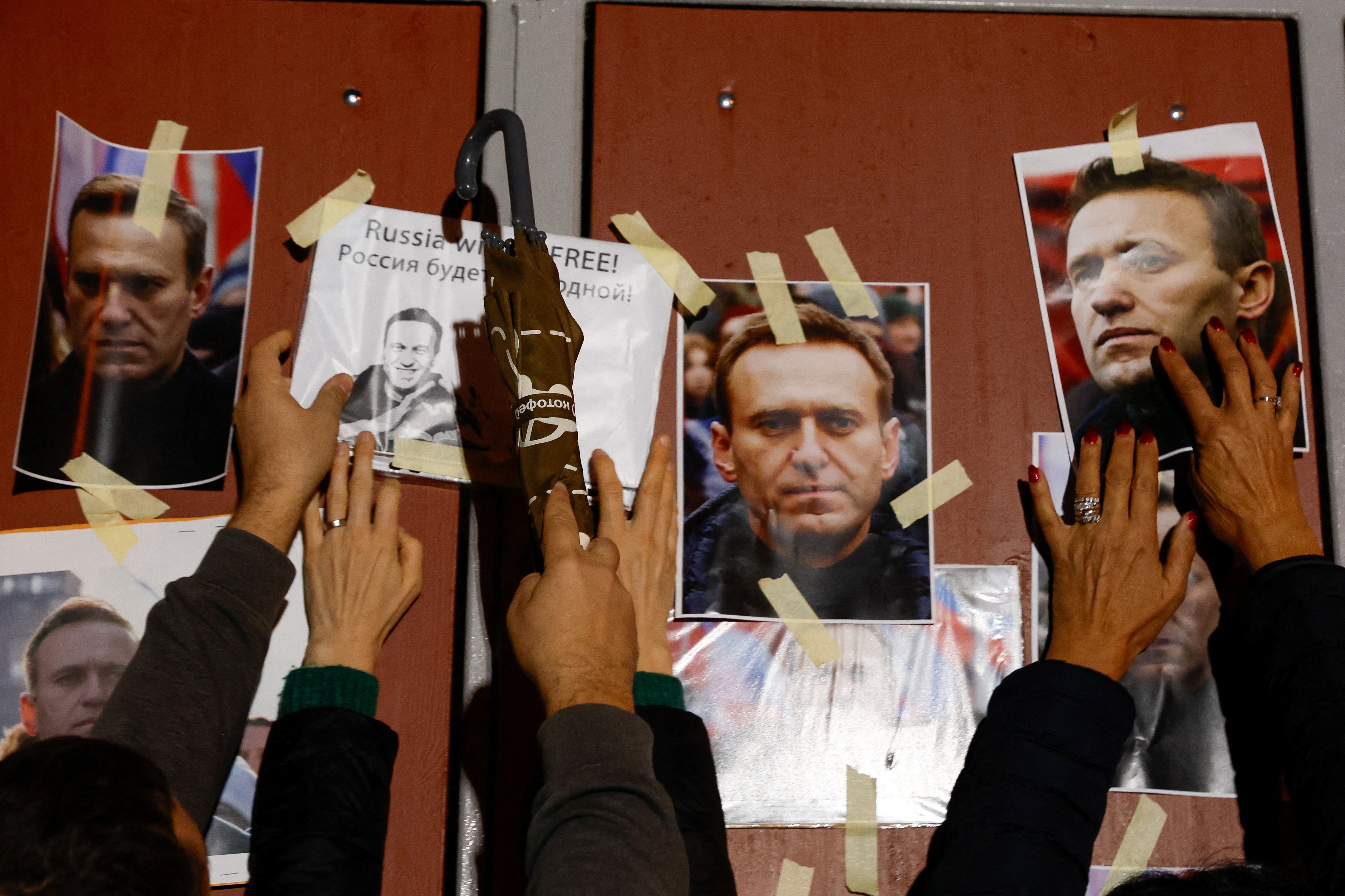 <p>People attend a protest and vigil following the death of Russian opposition leader Alexei Navalny, in Kappara</p>