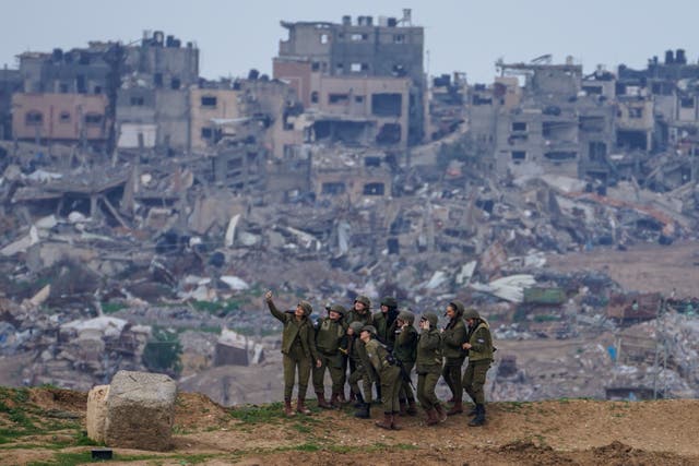 <p>Israeli female soldiers pose for a photo on a position on the Gaza Strip border, in southern Israel, Monday, Feb. 19, 2024. </p>