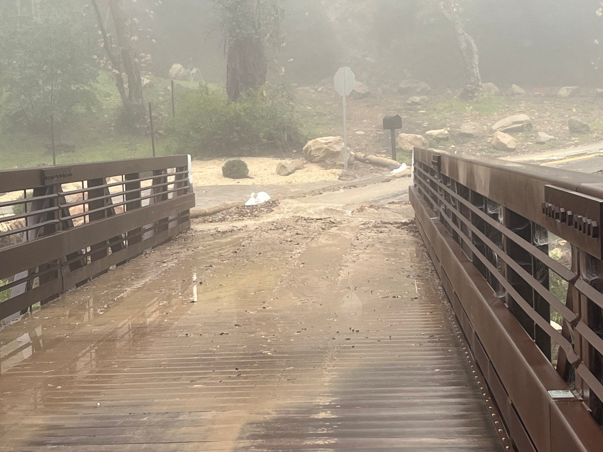 Floodwaters rush down a street in Montecito, California on Monday