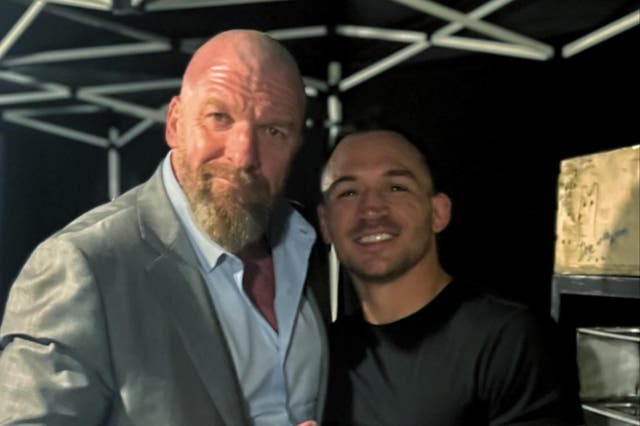 <p>Michael Chandler (right) with WWE executive and former wrestler Triple H</p>