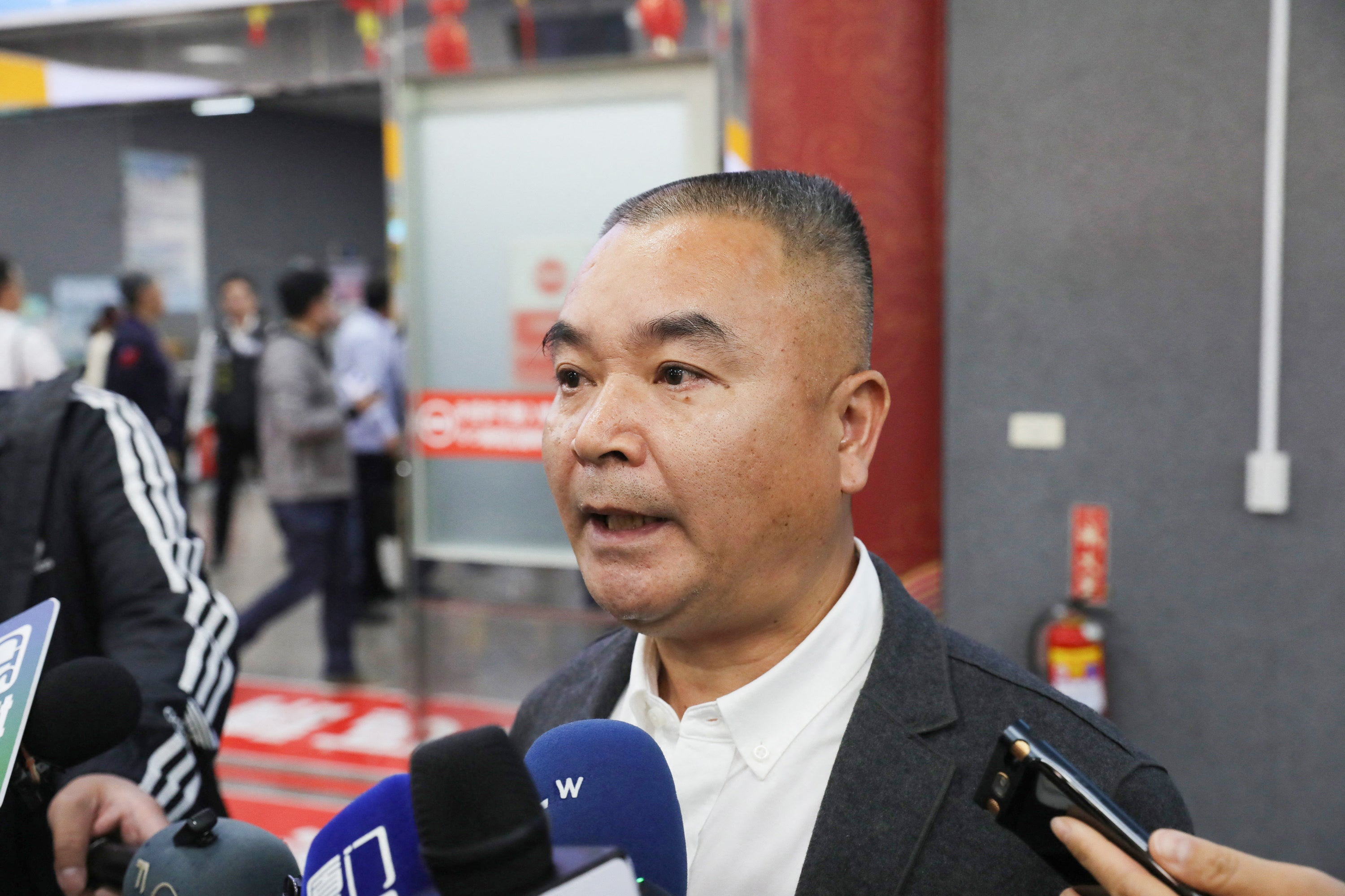 China’s Red Cross staff Li Chaohui speaking to the press upon his arrival in Kinmen as relatives of two fisherman arrive