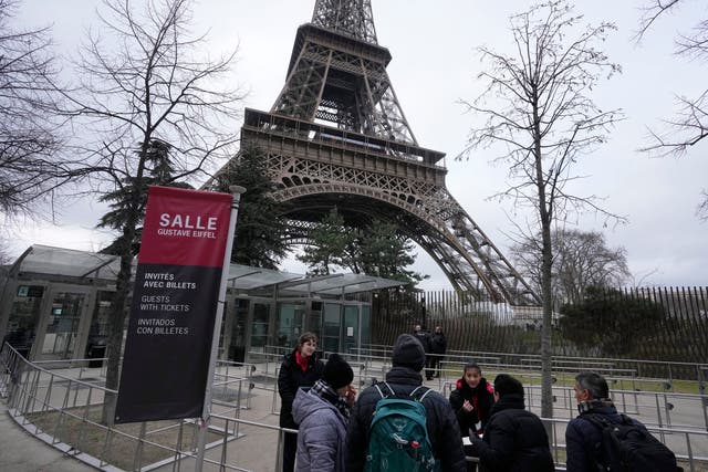 <p>Tour Eiffel employees talks to visitors at the Eiffel Tower on Tuesday</p>