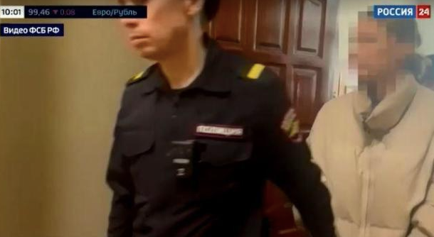 A screengrab from a video aired on Feb. 20, 2024 by Russia’s state-run broadcaster RU24 shows an LA woman being arrested and taken to court in Russia