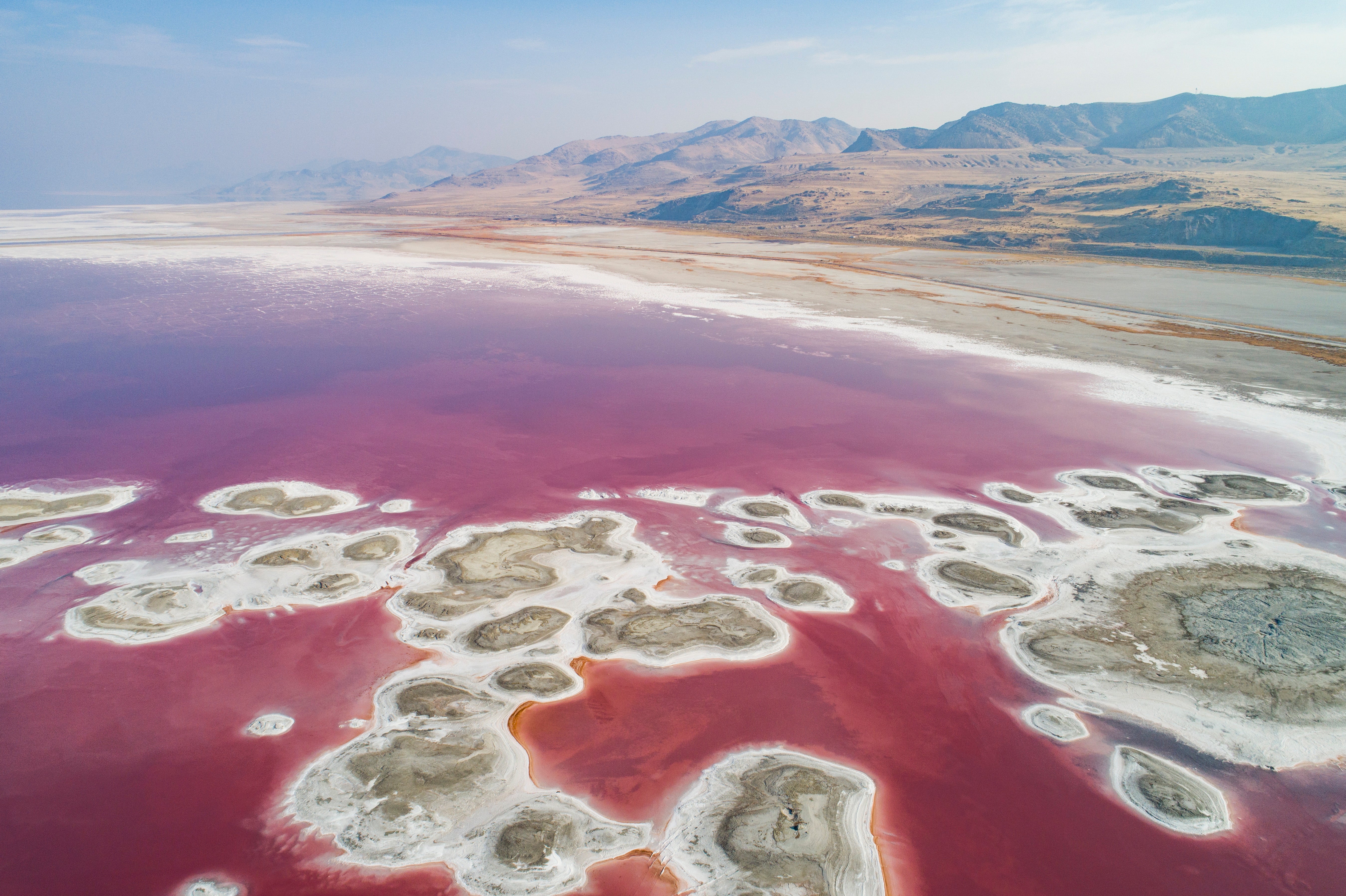 Varying levels of salinity cause different colours, with an algae that flourishes in higher salt content causing the red pigment