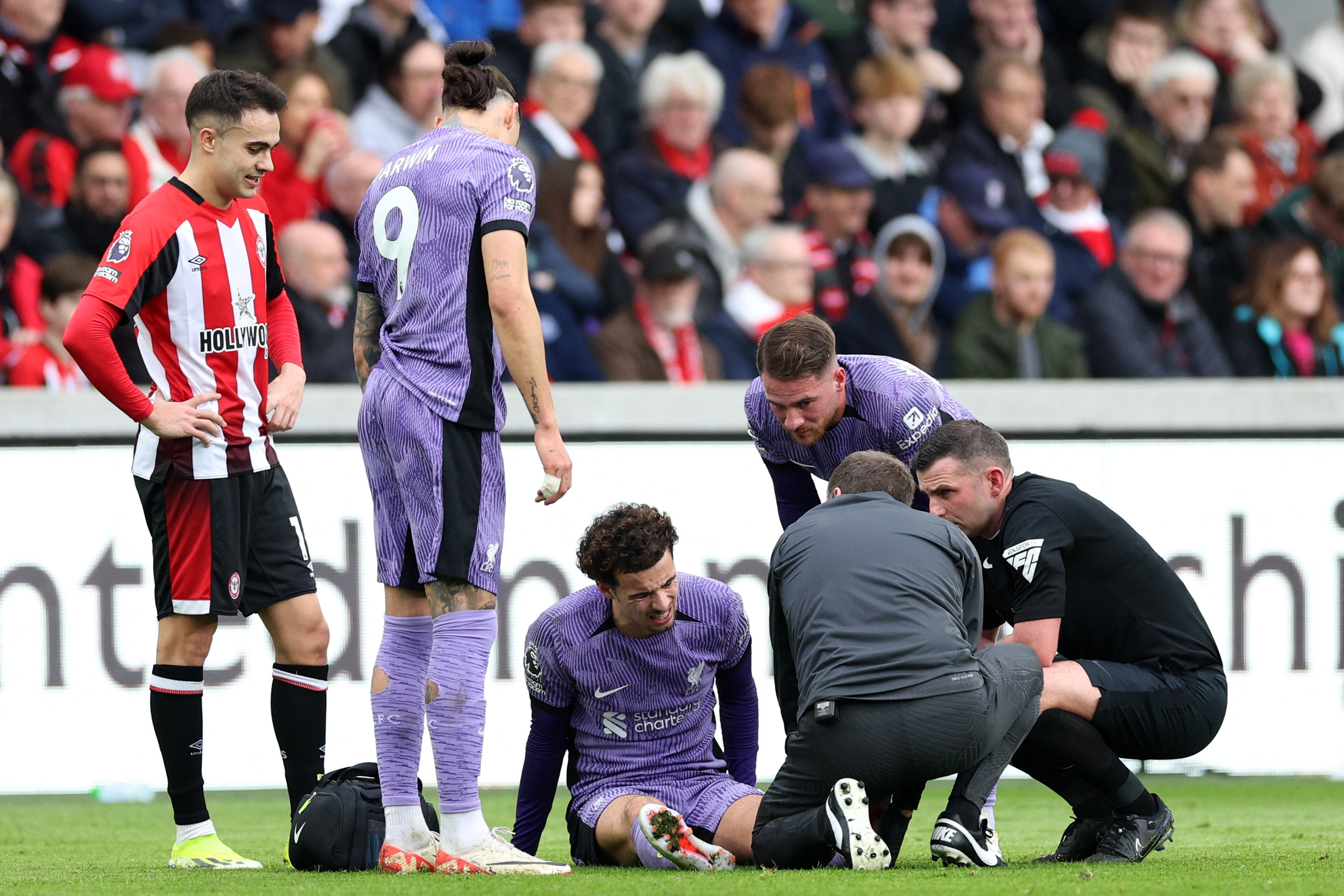 Curtis Jones is treated by medical staff in Liverpool’s game against Brentford