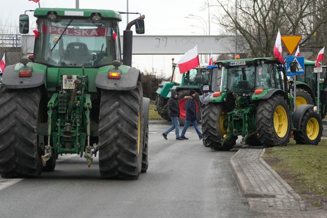 <p>Polish farmers drive tractors in a convoy as they intensify a nationwide protest against the import of Ukrainian foods</p>