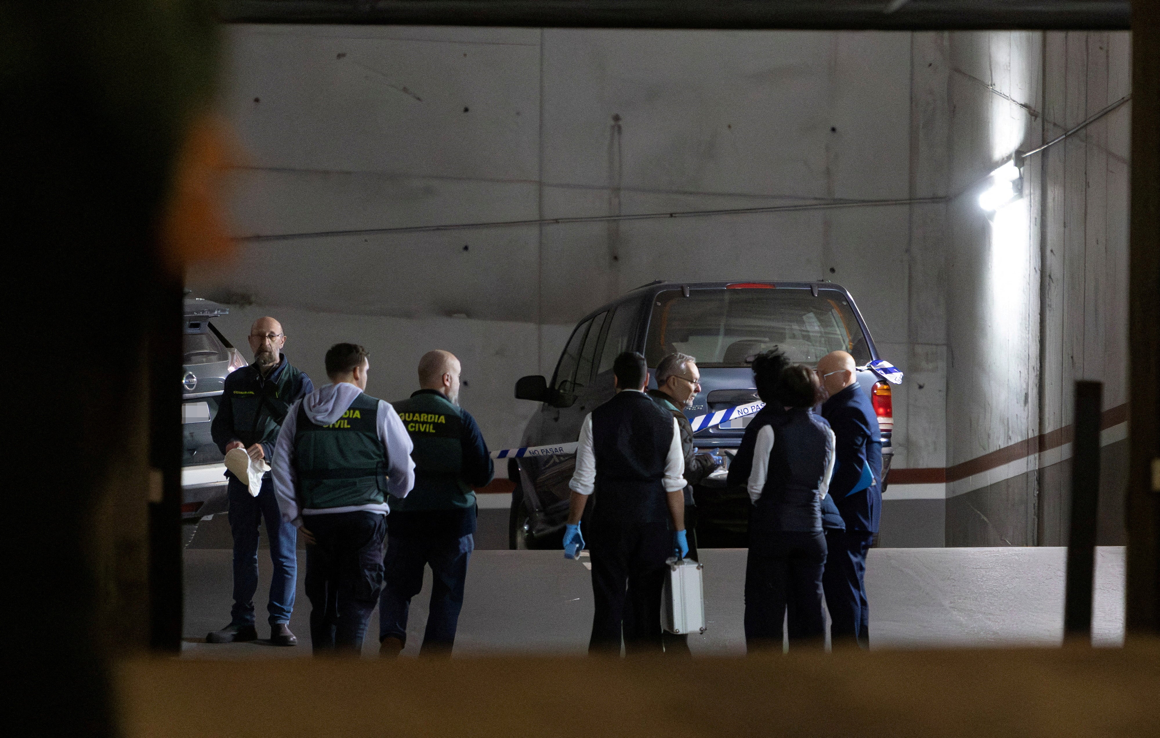 Spanish Guardia Civil officers investigate the garage where Mr Kuzminov’s body was found