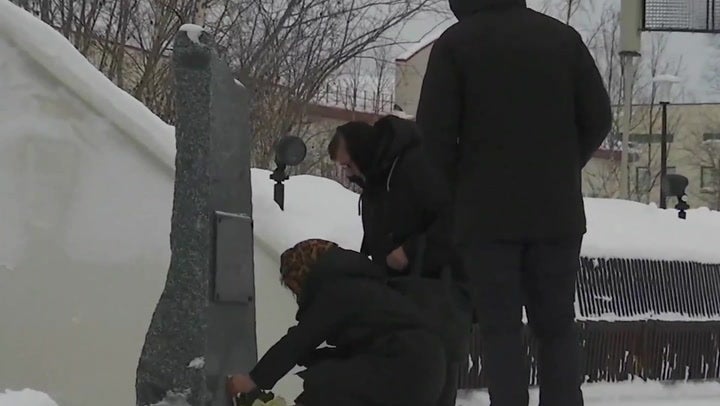 <p>Alexei Navalny’s mother Lyudmila Navalnaya lays flowers for her son.</p>