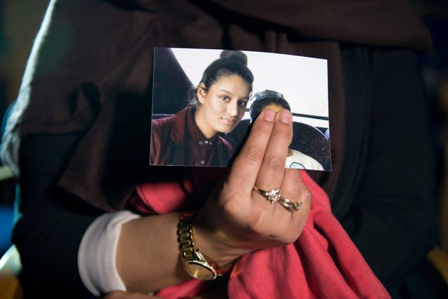 Renu, eldest sister of Shamima Begum, holds her sister’s photo while being interviewed by the media at New Scotland Yard, central London (Laura Lean/PA)