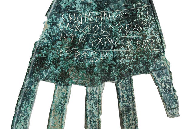 <p>The 2100 year old sheet bronze ‘severed hand’ symbol, with its inscription probably referring to a ‘good fortune’ deity</p>