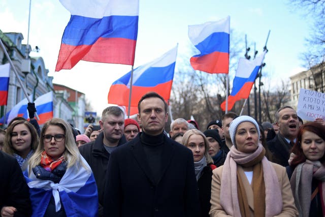 <p>Russian opposition leader Alexei Navalny and his wife Yulia march in memory of murdered Kremlin critic Boris Nemtsov in Moscow in February 2020</p>