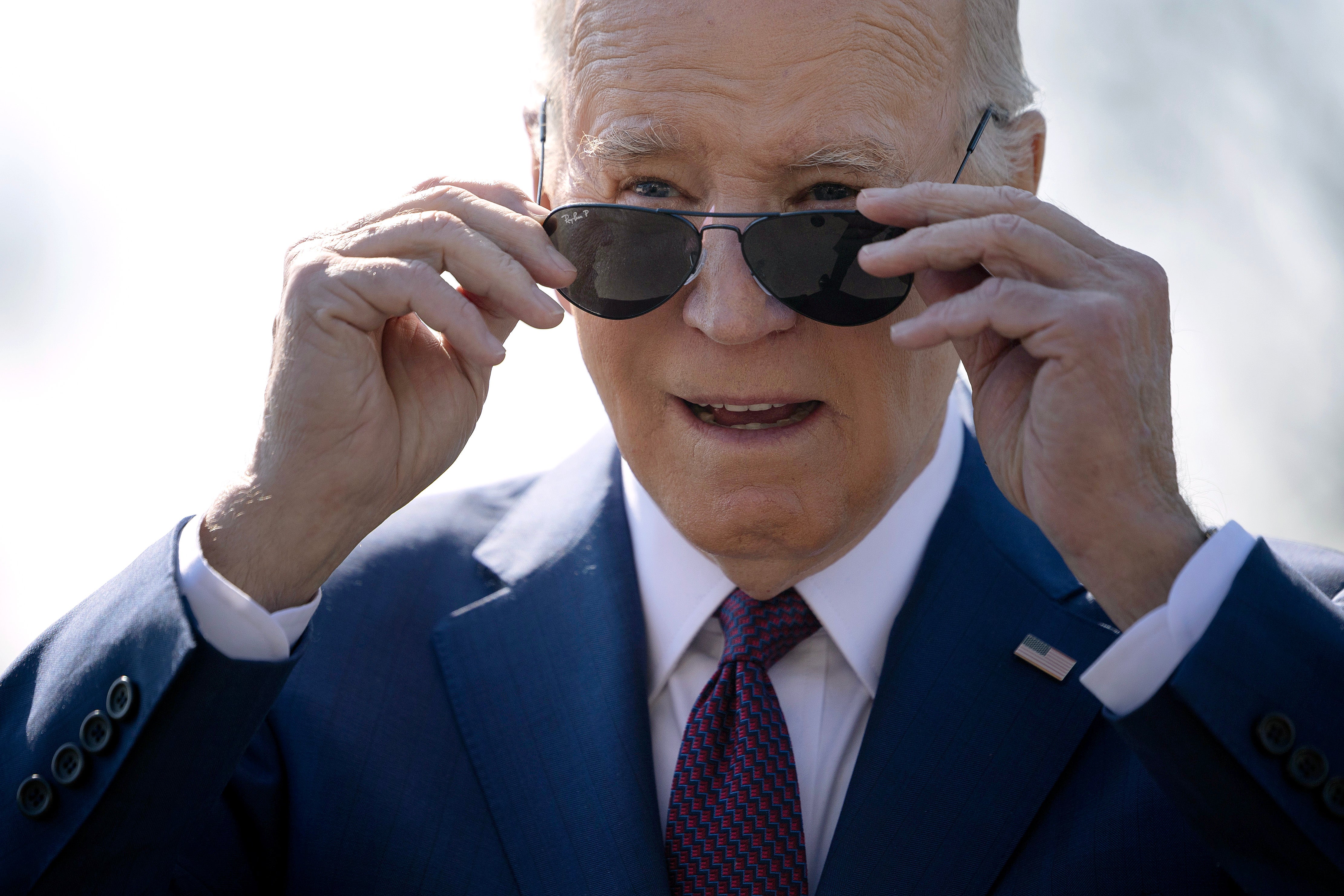 <p>Joe Biden stops to talk to journalists about new Russian sanctions as he departs the White House on 20 February 2024 in Washington, DC</p>