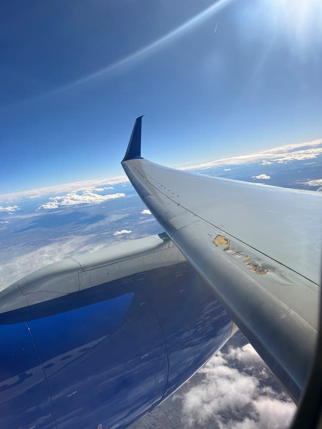 <p>Photo provided by Kevin Clarke shows a United Airlines plane with damage to one of its wings on Monday</p>