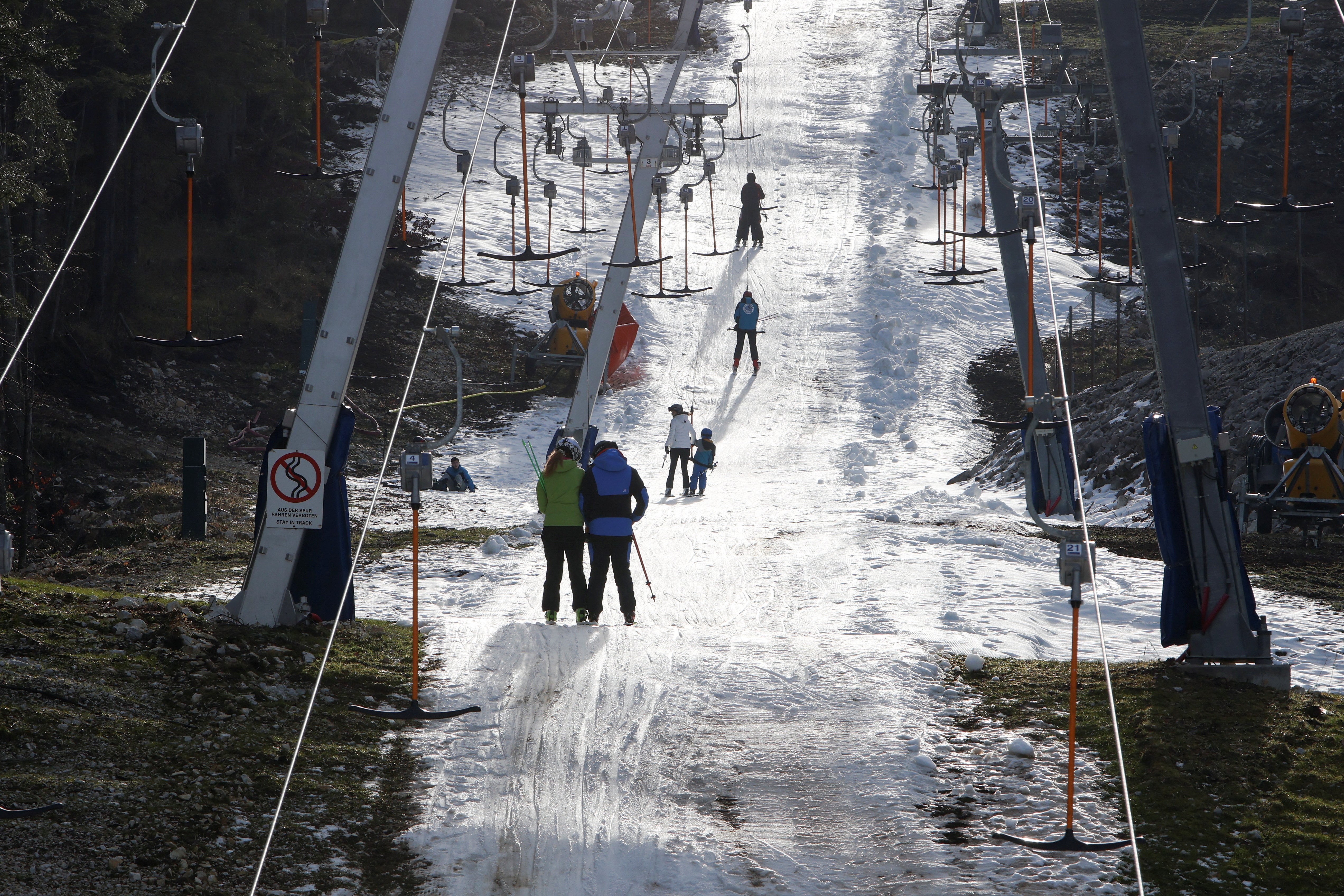 Visitors ride the ski lift during unseasonably warm weather on Mount Bjelasnica