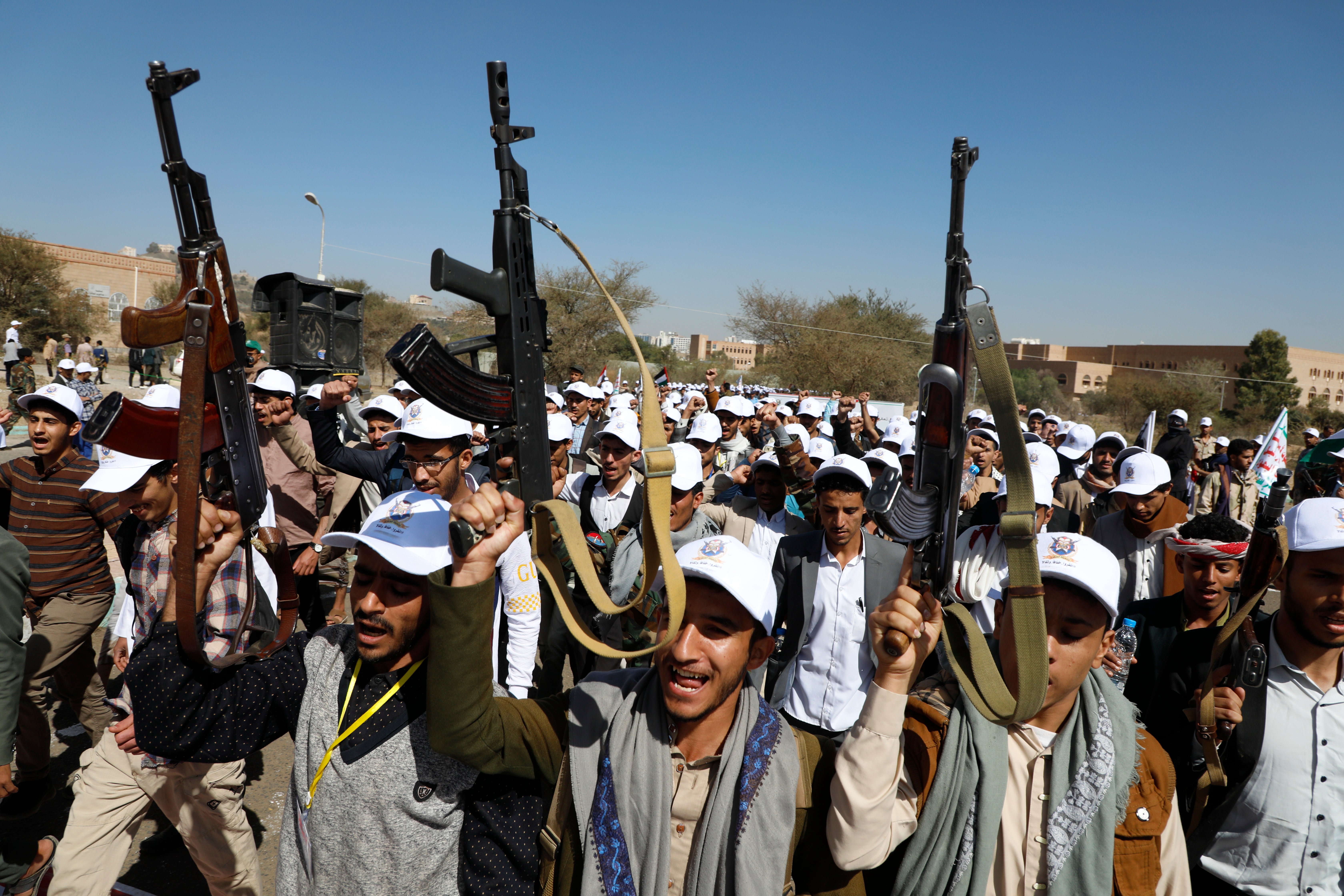 Newly recruited Houthi fighters attend a protest march against the US-led strikes on Yemen