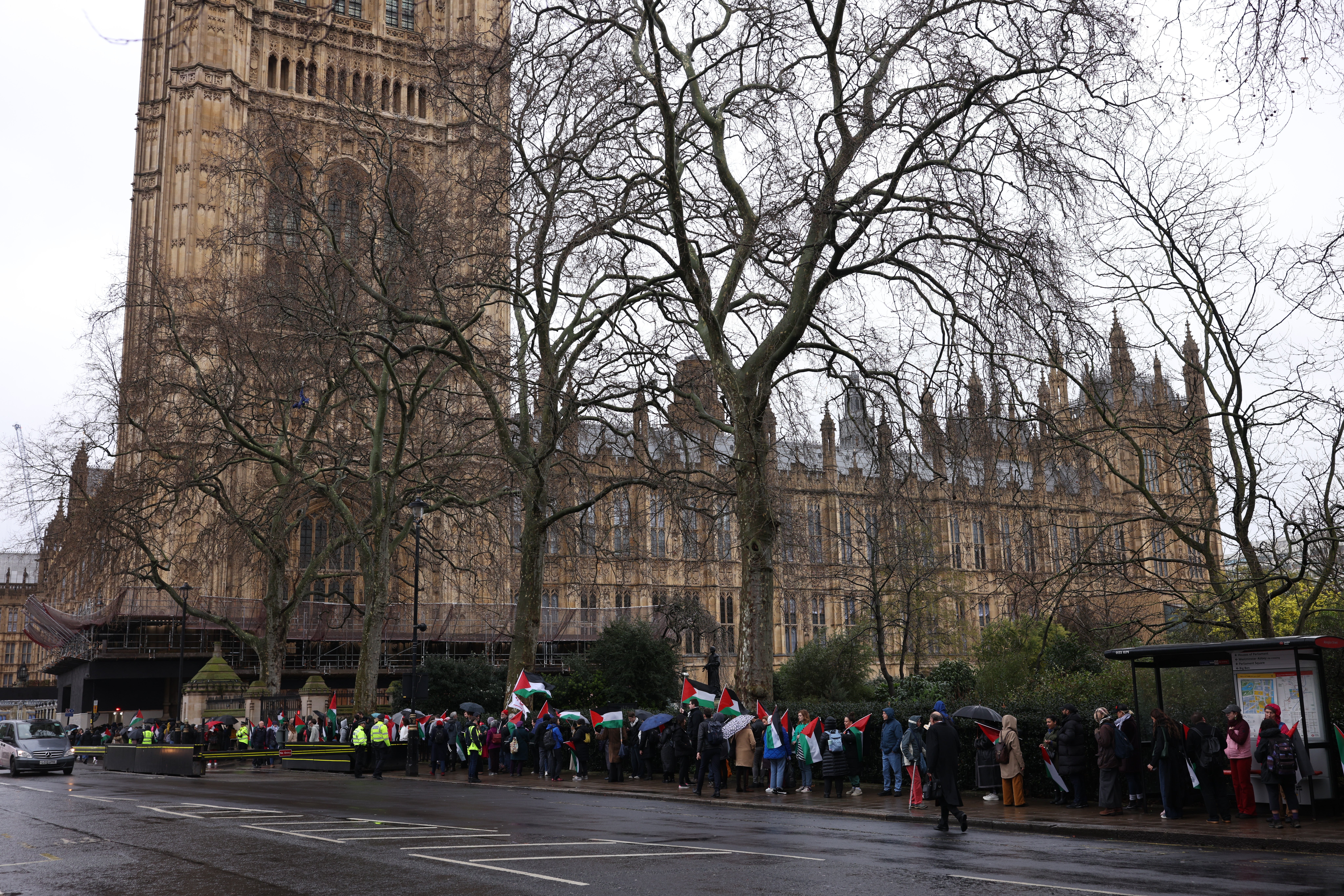 People with Palestinian flags queued to get into parliament for the Gaza vote