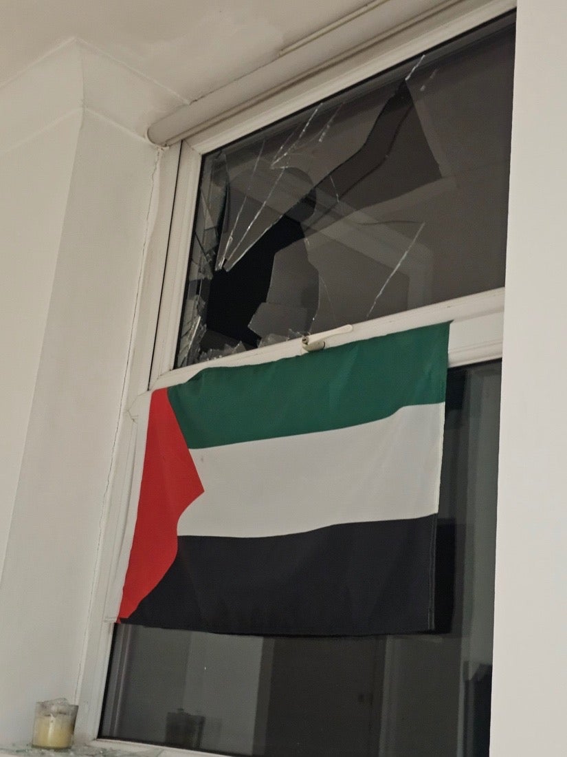 A doctor says he had a rock thrown through the window of his home in Manchester after displaying a Palestinian flag