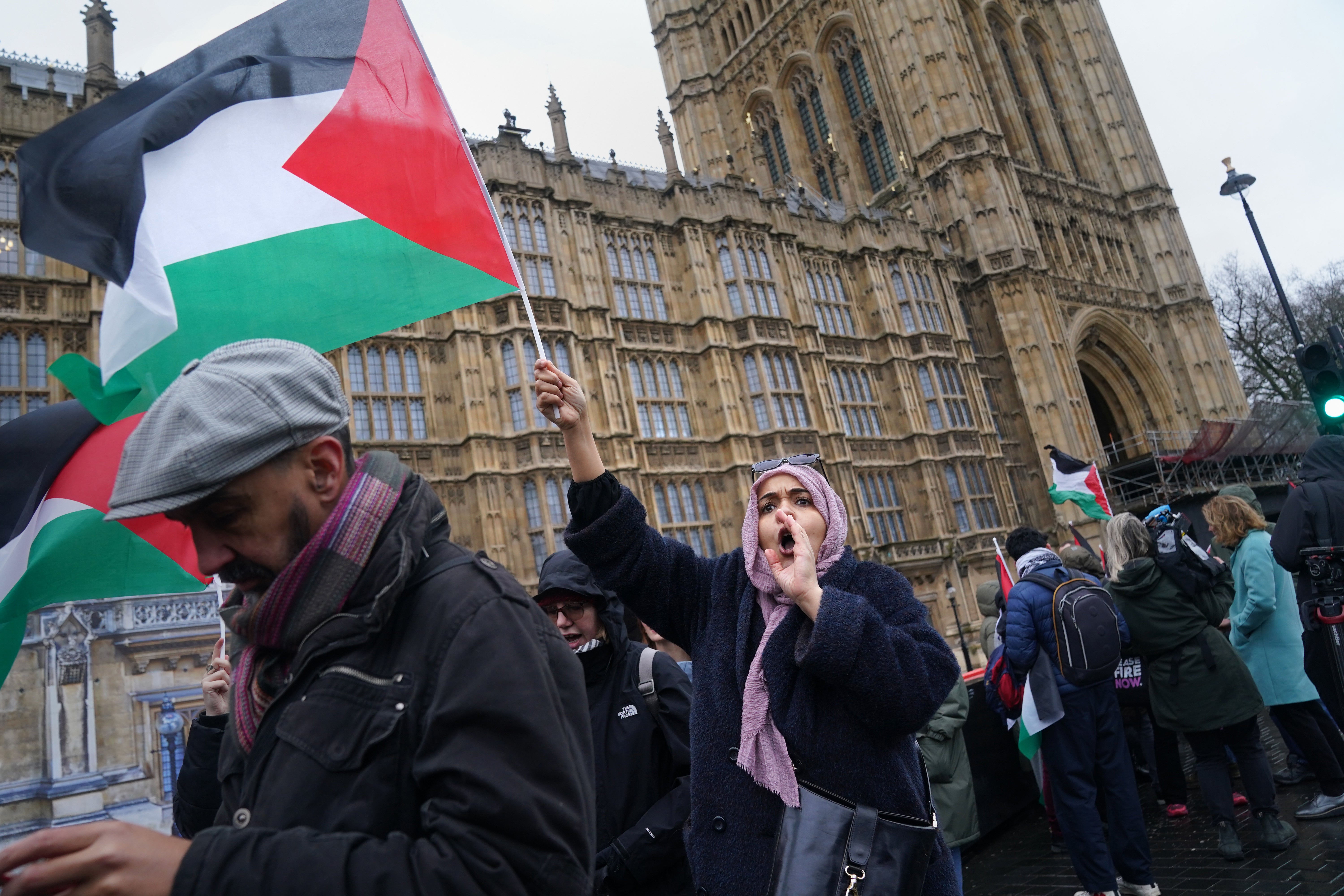 People take part in a Palestine Solidarity Campaign rally outside the Houses of Parliament