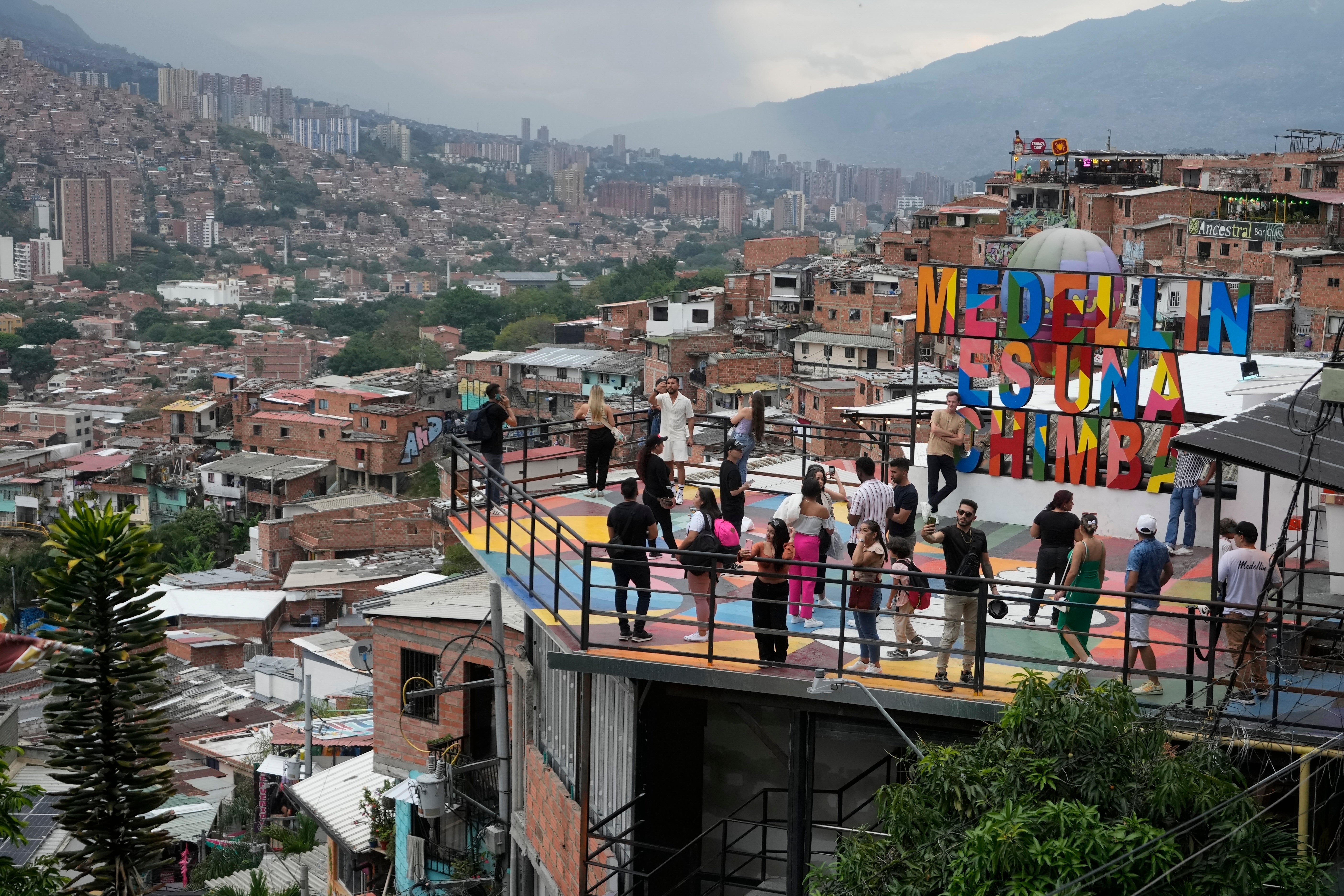 Tourists take photos in the Comuna 13 neighborhood of Medellin, Colombia