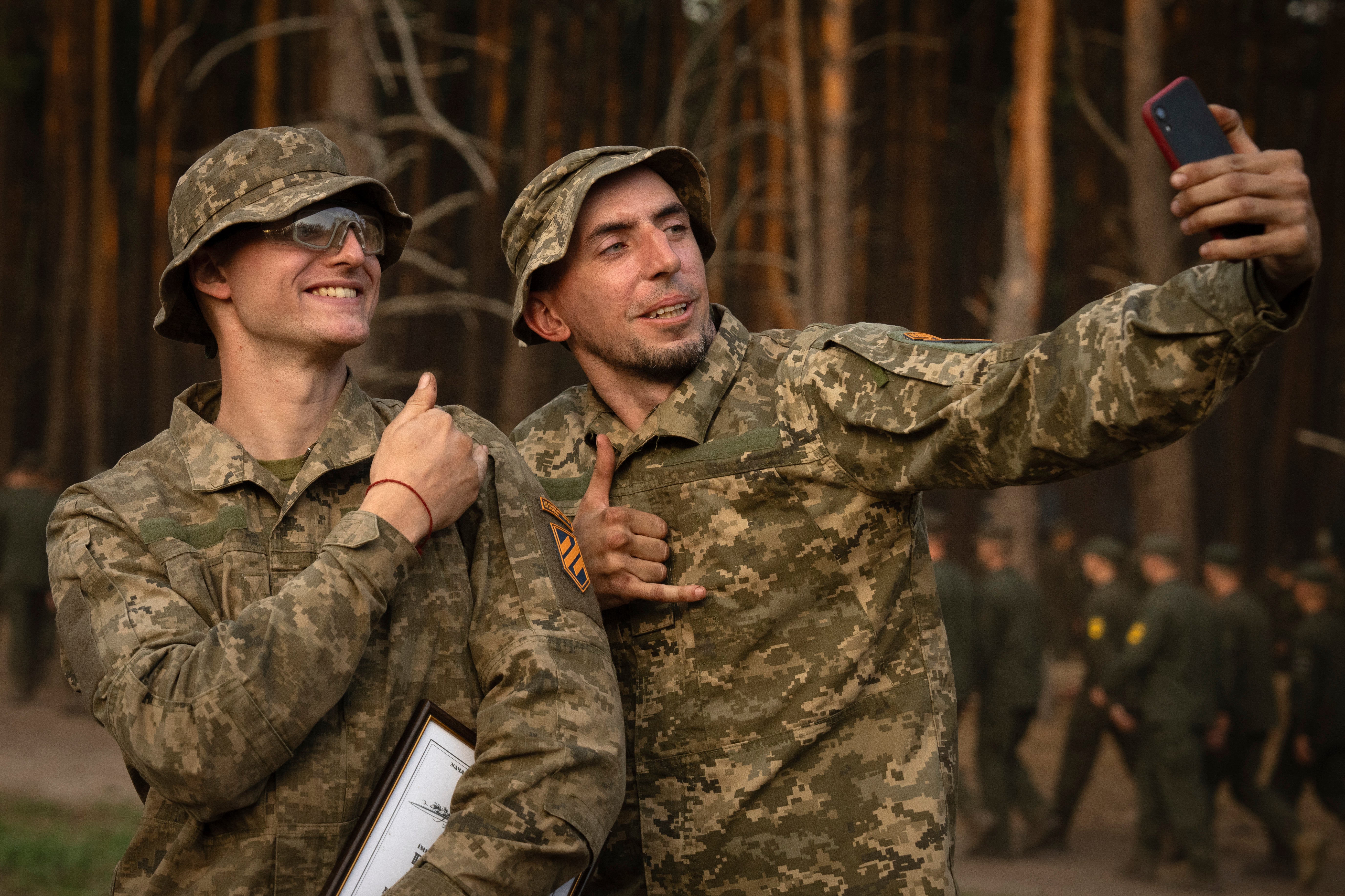 Newly recruited soldiers of the 3rd assault brigade take selfie to mark the end of their training