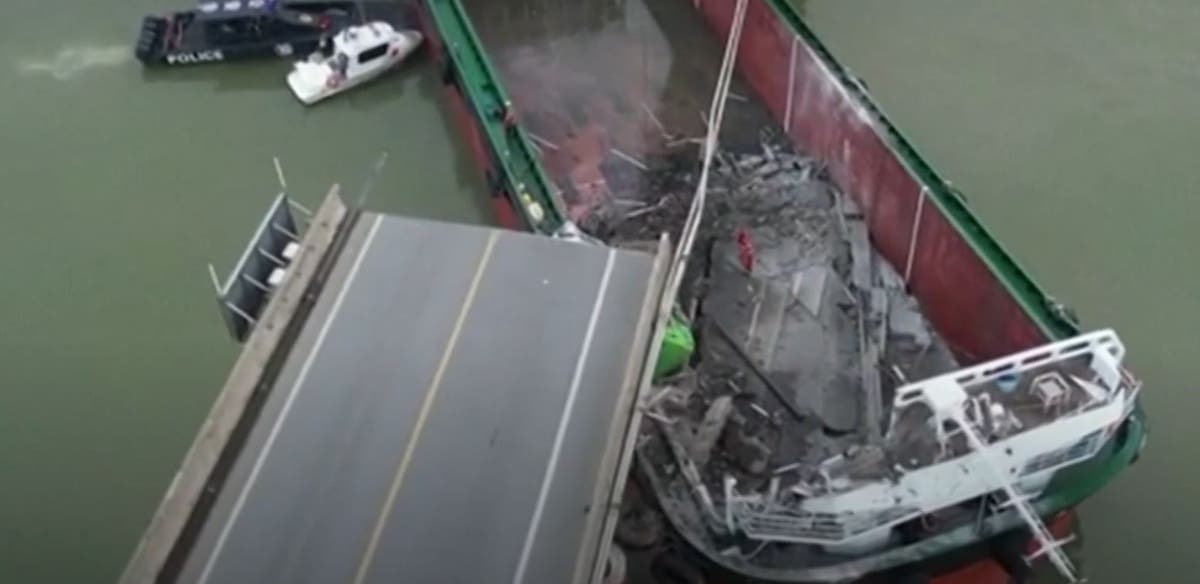 Two dead as ship slams into Chinese road bridge, sending cars flying into river