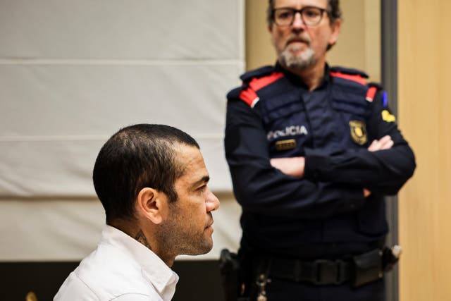 <p>Dani Alves sits during his trial in Barcelona</p>