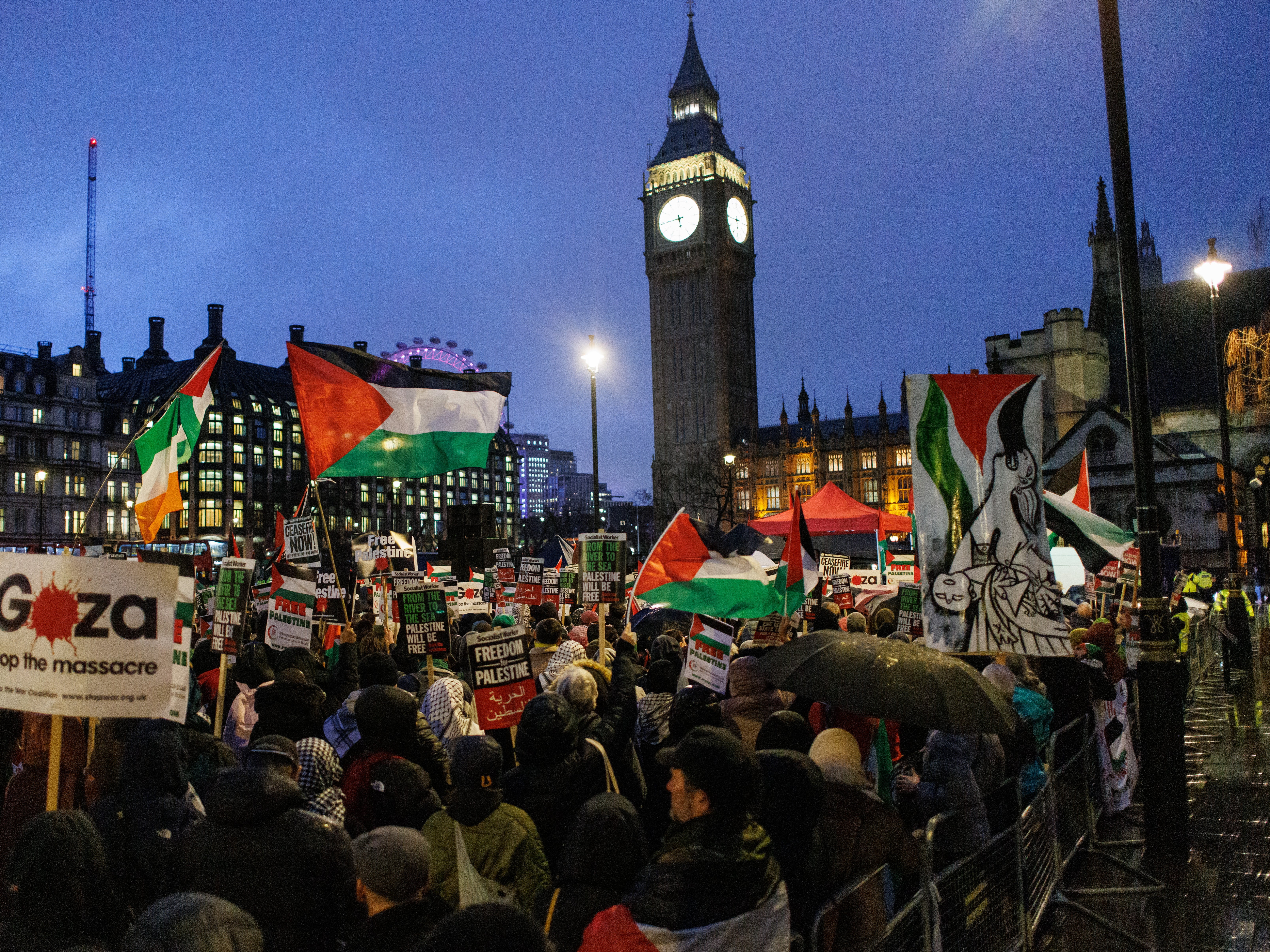 Pro-Palestinian protesters gather at Parliament Square as MPs debate a motion on calling a ceasefire in Gaza, on 21 February 2024