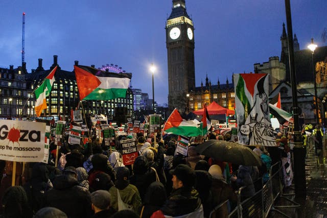 <p>Pro-Palestinian protesters gather at Parliament Square as MPs debate a motion on calling a ceasefire in Gaza, on 21 February 2024</p>