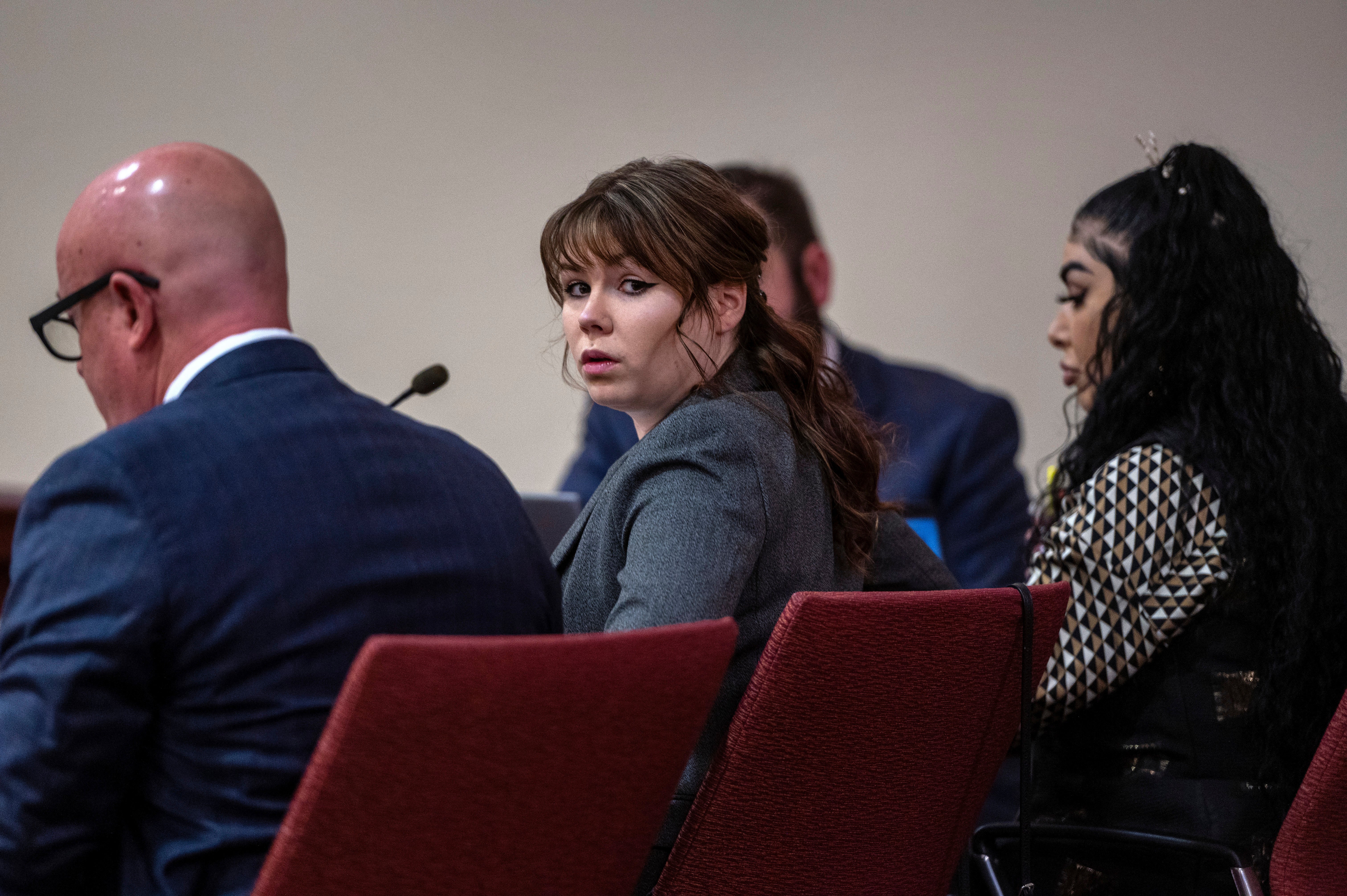 Hannah Gutierrez-Reed, center, sits with her attorney Jason Bowles, left, during the first day of testimony in the trial against her in First District Court, in Santa Fe, N.M., Thursday, February 22, 2024