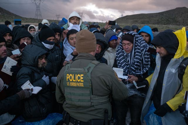 <p>People seeking asylum arrive at the US-Mexico border in California on 2 February. </p>