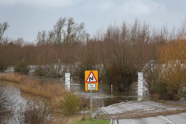 <p>The A1101 wash road in Welney in Norfolk is flooded with water to protect the wider area from flooding after pressure from rising river levels on Thursday</p>