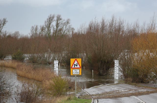 <p>The A1101 wash road in Welney in Norfolk is flooded with water to protect the wider area from flooding after pressure from rising river levels on Thursday</p>