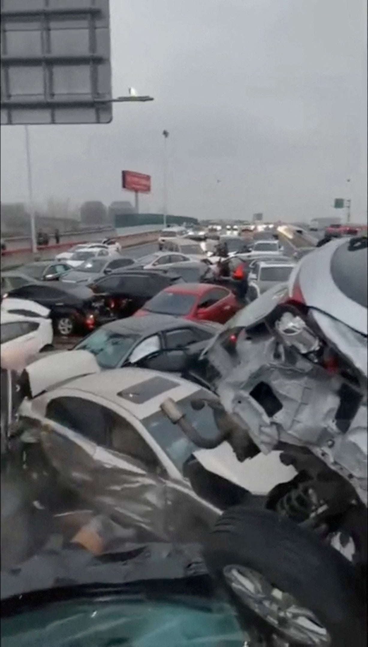 Cars pile up on an overpass during rainy and snowy weather in Suzhou